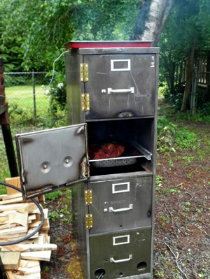 Here are some construction ideas, note the tray that hangs in the drawer slides. The fire goes in the bottom drawer where you used to file personnel records. This model has hinged door so you don’t burn your hands retrieving an office party sized roast.